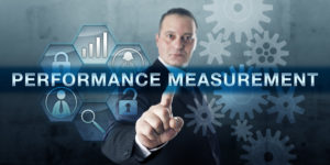 Engineering professional is pressing PERFORMANCE MEASUREMENT on a virtual interactive flat screen. Business concept for collecting data and analyzing information on processes and corporate strategy.